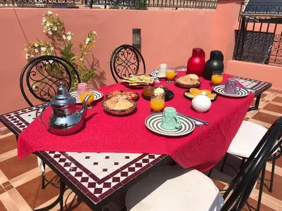 a table with a red table cloth with food on it at Hostel Amour d'auberge in Marrakech