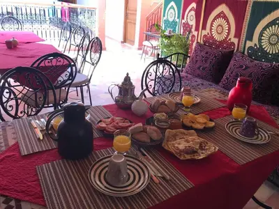 a table with a red table cloth with food on it at Hostel Amour d'auberge in Marrakech