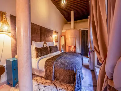 a bedroom with a large bed in a room at Riad Ines Home in Marrakech