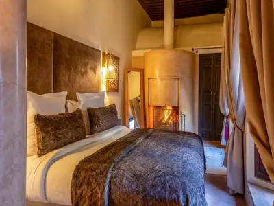 a bedroom with a large bed in a room at Riad Ines Home in Marrakech