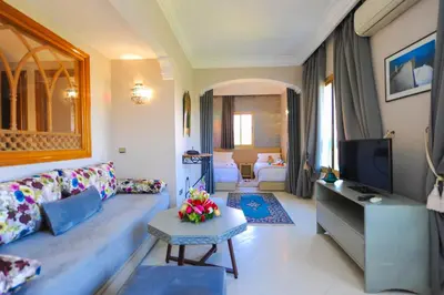 a living room with a couch and a tv at Appart-Hotel Amina Resort & Spa in Marrakech