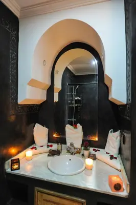a bathroom with a sink and a mirror at In Club Palmeraie Resorts in Marrakech