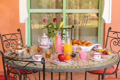 a table with breakfast foods and drinks on it at In Club Palmeraie Resorts in Marrakech