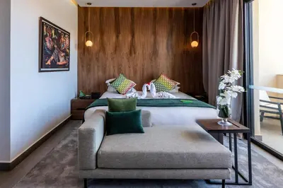 a hotel room with a bed and a couch at Sirayane Boutique Hotel & Spa Marrakech in Marrakech