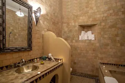 a bathroom with a sink and a mirror and a tub at Riad Ciel d'Orient in Marrakech