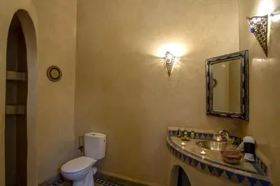 a bathroom with a toilet and a sink and a mirror at Riad Ciel d'Orient in Marrakech