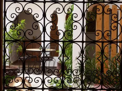 a black iron gate with a table in a room at Riad Safina in Marrakech