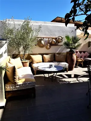 a patio with a couch and a table at Riad Safina in Marrakech