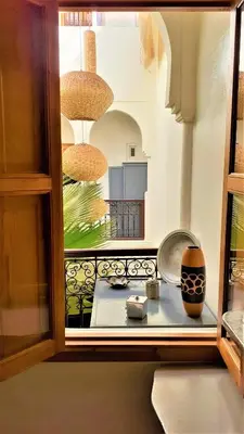 a room with a window with a vase on a table at Riad Safina in Marrakech