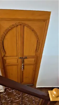 a wooden door in the corner of a room at Riad Safina in Marrakech