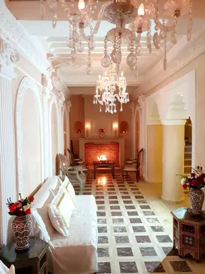 a living room with a couch and a chandelier at Riad Palais Des Princesses & Spa in Marrakech