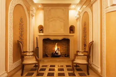 a living room with two chairs and a fireplace at Riad Palais Des Princesses & Spa in Marrakech