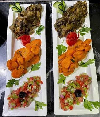 three white plates with different types of food on them at Riad Jardin Des Rêves in Marrakech