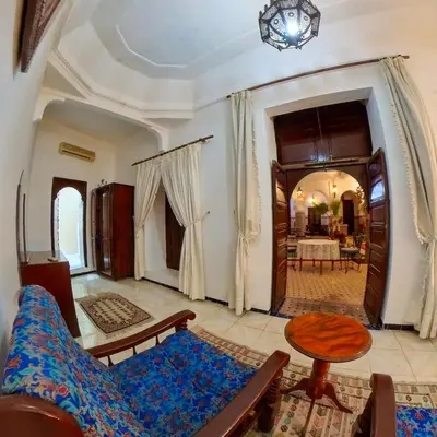 a living room with a couch and a table at Riad Dar Moulay Ali in Marrakech