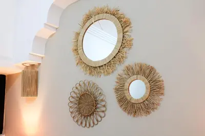 two mirrors on a wall next to a wall at Riad Amra in Marrakech