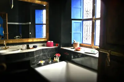 a bathroom with two sinks and a mirror at Riad Ayadina & SPA in Marrakech