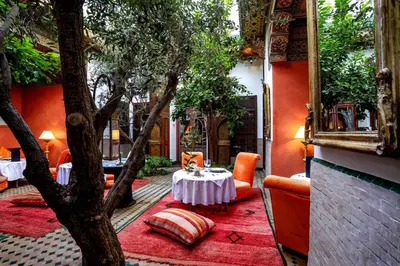a room with a tree and a table and chairs at Riad Ayadina & SPA in Marrakech