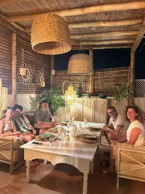 a group of people sitting around a table in a room at Riad Les Orangers D'alilia in Marrakech