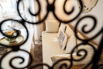 a room with a couch and a table with a mirror at Riad Les Orangers D'alilia in Marrakech