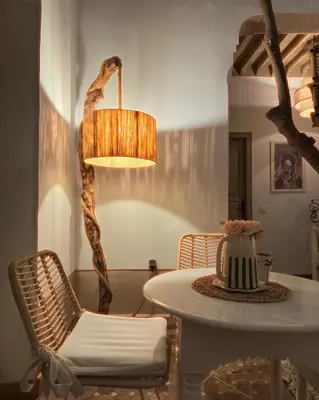 a room with a table and a chair and a lamp at Riad Les Orangers D'alilia in Marrakech