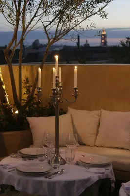 a table with two candles on it with a couch at Riad Moullaoud in Marrakech