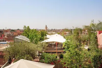 a view of a restaurant with umbrellas and trees at Riad Moullaoud in Marrakech