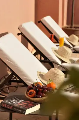 a table with a bowl of fruit on top at Riad Le Jardin d'Abdou in Marrakech