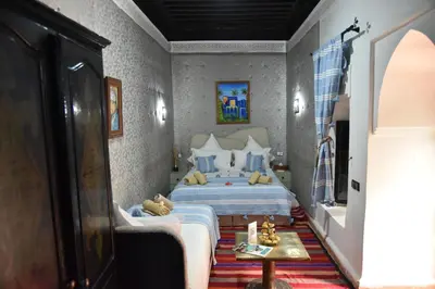 a bedroom with a bed with a teddy bear on it at Riad Du Petit Prince in Marrakech