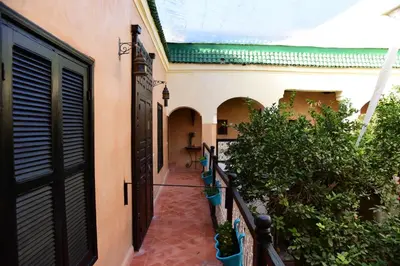 an alleyway leading to a building with an open door at Riad Du Petit Prince in Marrakech