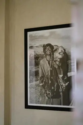 a framed picture of two people on a wall at Riad O in Marrakech