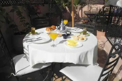a white table with plates of food and drinks on it at Riad Linda in Marrakech