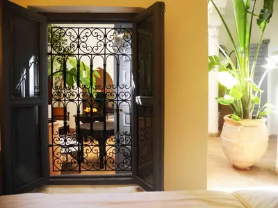 a door with a iron gate in a room at Riad Linda in Marrakech