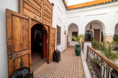 an entrance to a house with a large wooden door at Riad Le Jardin de Lea, Suites & Spa in Marrakech
