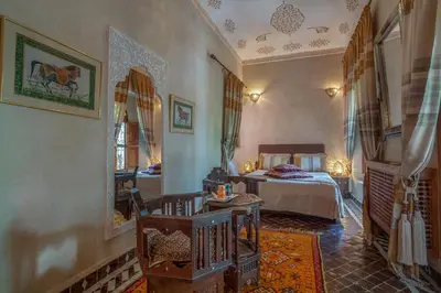 a room with a bedroom with a bed in it at Riad & Spa Laurence Olivier in Marrakech
