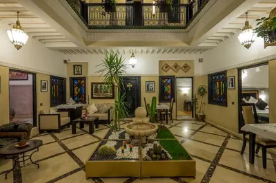 a living room with a fountain in the middle of the room at Riad Nesma Suites & Spa in Marrakech