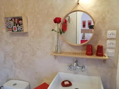 a bathroom with a mirror and a white sink at Riad Dar Nouba in Marrakech