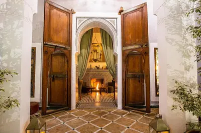 an open door into a living room with a fireplace at Riad Le Rihani in Marrakech