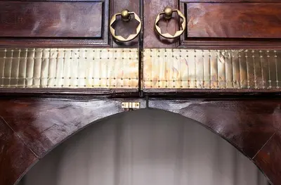 an archway in a wooden cabinet with handles at Dar Sohane in Marrakech