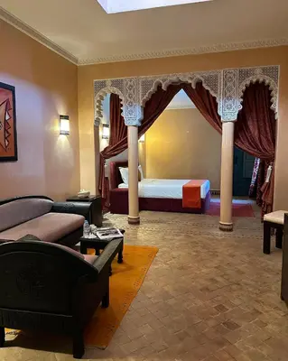 a living room with a bed and a couch at Palais Riad Berbère in Marrakech