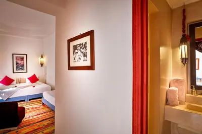 a hotel room with a bed and a bathroom at Hotel & Spa Dar Baraka & Karam in Marrakech