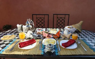 a table with plates of food on a table at Riad Christina in Marrakech