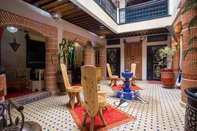 a room with chairs and a table in a room at Riad Christina in Marrakech