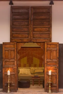 a large wooden bed with two candles in a room at Riad Kasbah & Spa in Marrakech