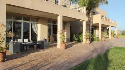 a house with couches sitting outside of it at Palais Ambrine in Marrakech