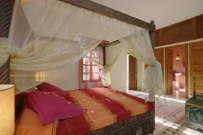 a bedroom with a bed with a canopy at Riad Cannelle in Marrakech