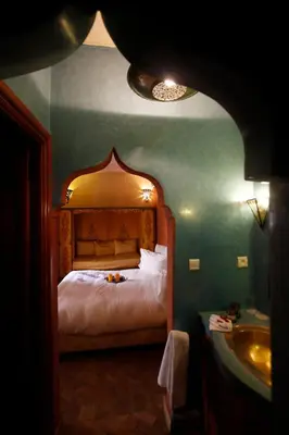 a bedroom with a bed and a sink at Riad Léna & Spa in Marrakech
