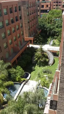 a view of a courtyard in a city with buildings at Ritaj Apartement in Marrakech