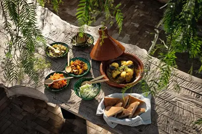 a picnic table with plates of food on it at Riad Kbour & Chou in Marrakech