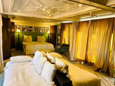 a hotel room with two beds and yellow curtains at Riad Fabiola Et Spa By La Siredrah in Marrakech