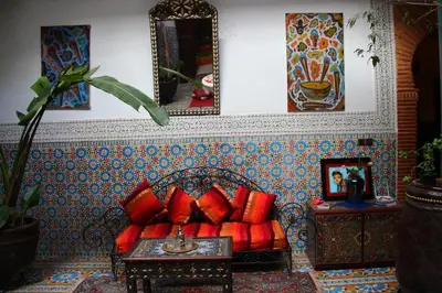 a living room with a couch with red pillows at Riad Bibtia in Marrakech